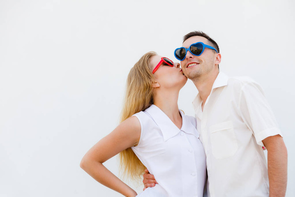 Man and woman wearing heart shape sunglasses - Fotoğraf, Görsel