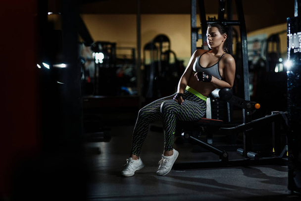 athletic woman in gym resting sitting before exercise - Valokuva, kuva