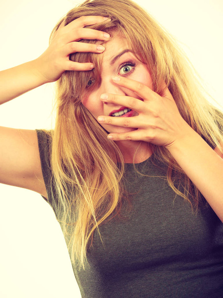 Ashamed embarrassed blonde woman with hands on face - Fotoğraf, Görsel