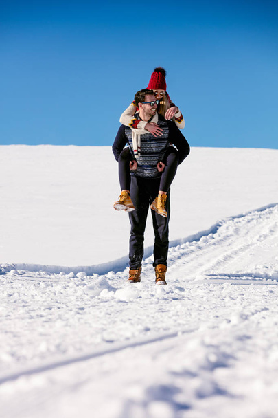Man giving woman piggyback ride  - Фото, зображення