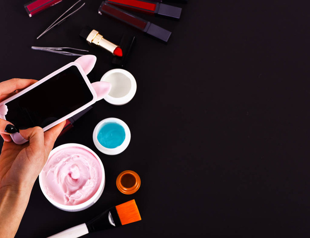 various cosmetics: cream, gel, lipsticks, brushes and tweezers - Foto, imagen