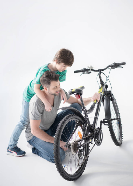 Father and son with bicycle - Fotoğraf, Görsel