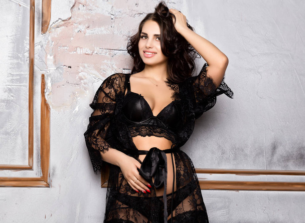 fashion sexy young woman in black lacy lingerie and stockings posing on old wall - Foto, afbeelding