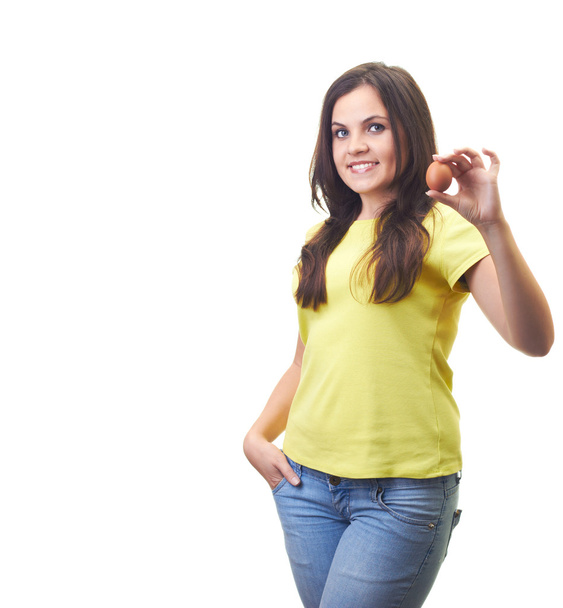 Attractive young woman in a yellow shirt holding in her left han - Φωτογραφία, εικόνα