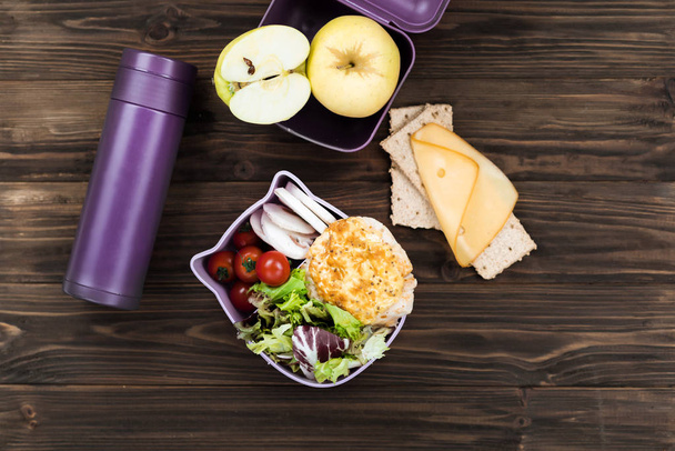Violet thermos lying near the lunch box - Photo, image