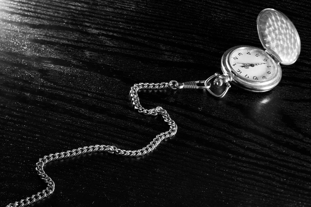Pocket watch on a table - Fotó, kép