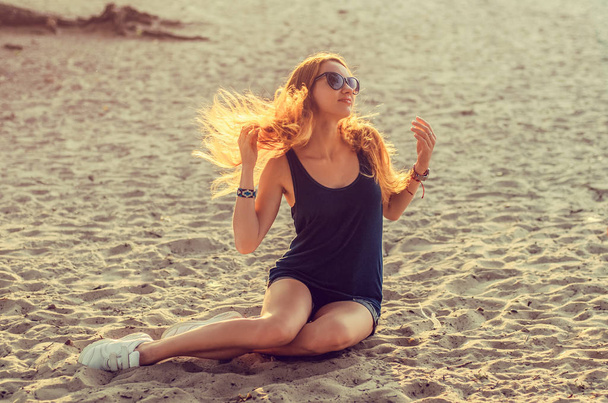 Slim redhead woman on a beach - Фото, изображение