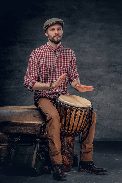 Man plays on ethic wooden drums - Photo, Image