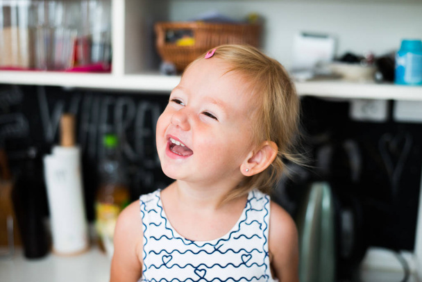 Cute little happy girl at home laughing - 写真・画像
