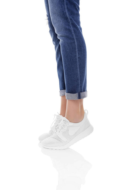 Womens legs in jeans and sneakers. - Fotoğraf, Görsel