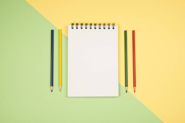Top view of blank notebook page with colored pencils - Valokuva, kuva