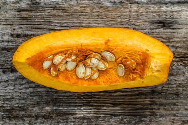 Cut pumpkin slice on wooden background, top view - Photo, image