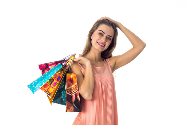 belle fille garde la balle derrière sa tête et soudain main tient paquets colorés avec des cadeaux est isolé sur un fond blanc
 - Photo, image