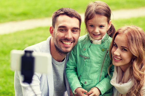 happy family taking selfie by smartphone outdoors - Fotó, kép