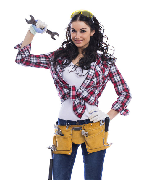 Sexy brunette woman mechanic with a wrench - Foto, afbeelding