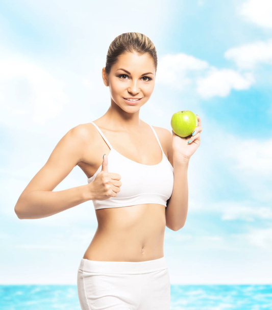 woman in white lingerie with green apple - Photo, Image