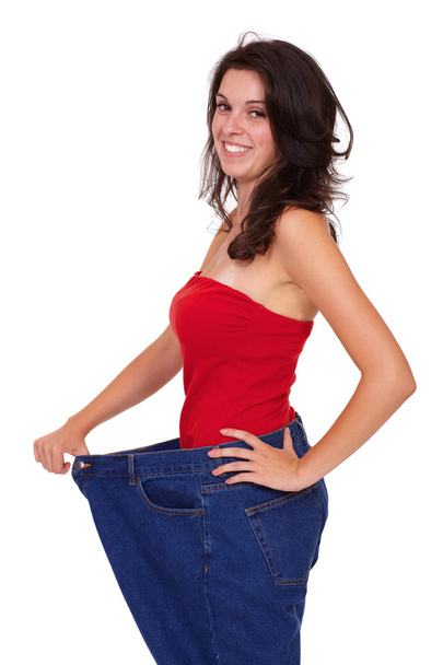 Young smiled happy slim beautiful girl in her old pair of jeans - Foto, Imagen
