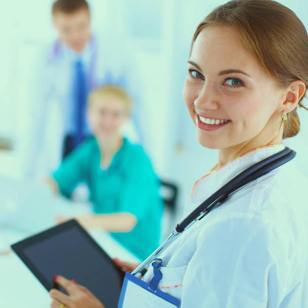 Woman doctor standing at hospital witih folder - Zdjęcie, obraz