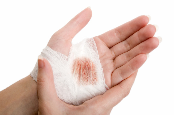Foto de parent applying band aid on finger wound. hands, cut, blood, bandage.  do Stock