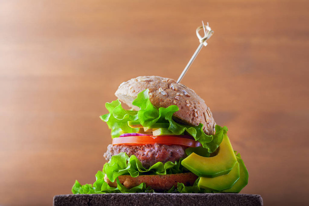 Delicious homemade burger on rustic wooden desk. - Photo, Image