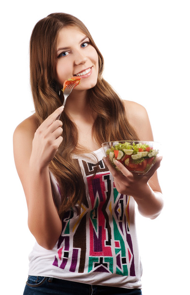 Portrait of a girl looking positive and holding a bawl with salad - Foto, Bild