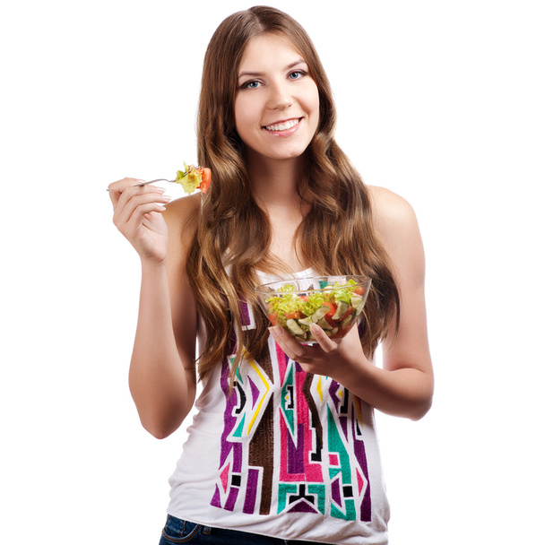 Portrait of a girl looking positive and holding a bawl with salad - Foto, Bild