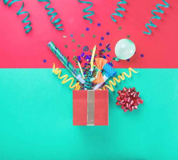 Red gift box with colorful party items - Fotoğraf, Görsel
