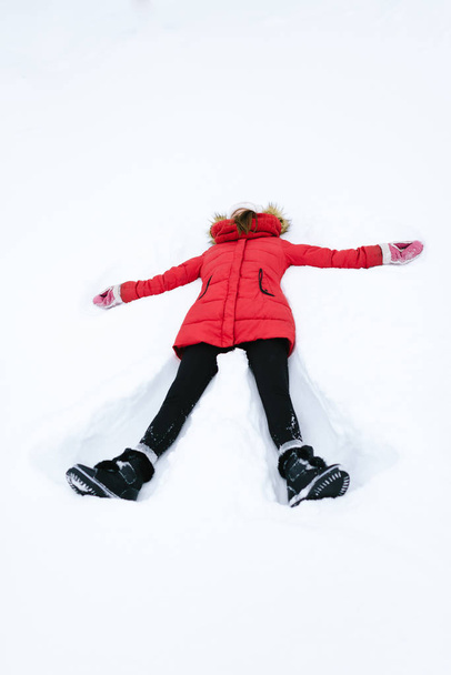 girl in a red jacket in winter - Photo, Image