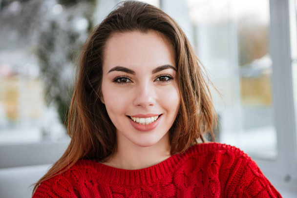 Happy beautiful young woman in red knitted sweater - Foto, Imagem
