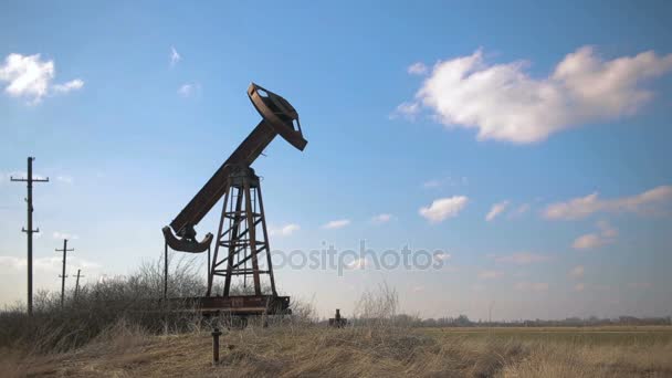 broken and abandoned oil pump on a background of blue sky and white clouds. - Footage, Video