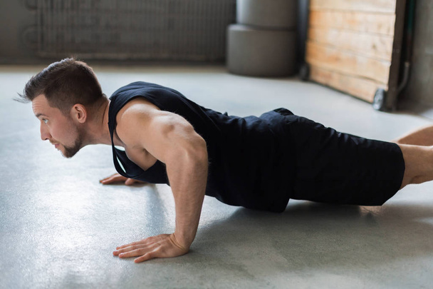 Young man fitness workout, push ups or plank - Fotografie, Obrázek