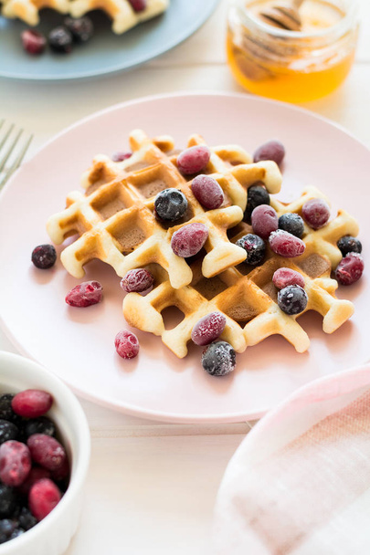 Belgian waffles with honey and frozen berries  - Photo, image
