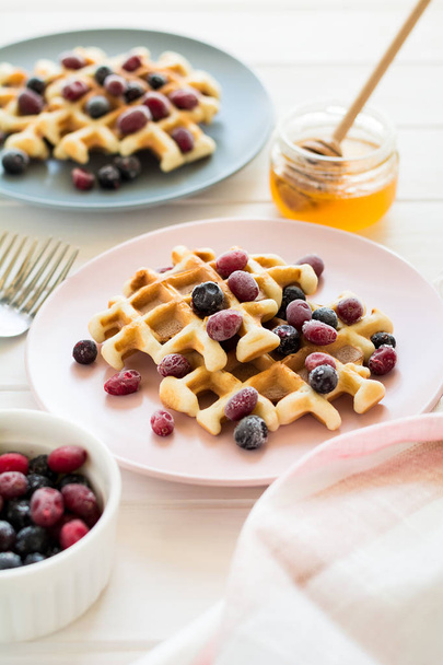 Belgian waffles with honey and frozen berries  - Photo, image