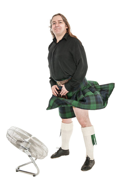 Scottish man in traditional national costume with blowing kilt  - Photo, Image