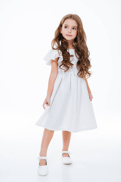 Full length of little girl in dress standing and posing - Foto, Imagen