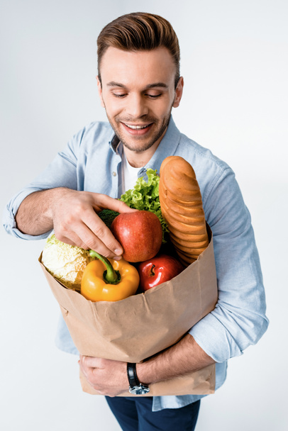 Man holding grocery bag  - Фото, изображение