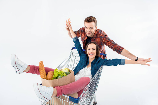 Couple with shopping cart - Foto, afbeelding