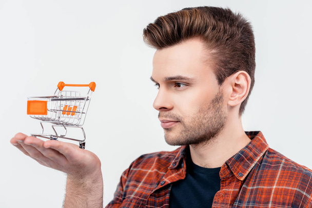 man holding shopping cart model - Фото, изображение