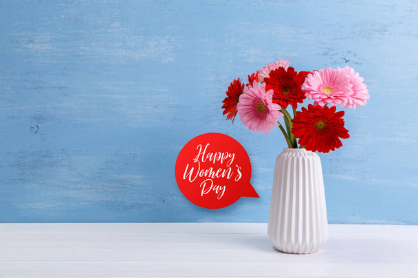 Gerbera flowers in vase on wooden background. - Фото, изображение