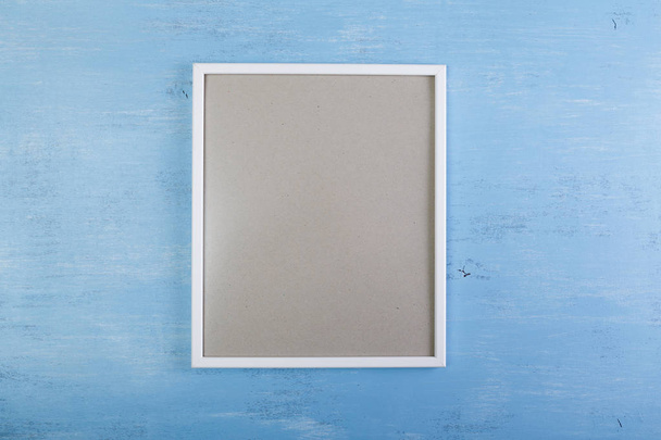 Blank photo frame on blue wood background. - Φωτογραφία, εικόνα