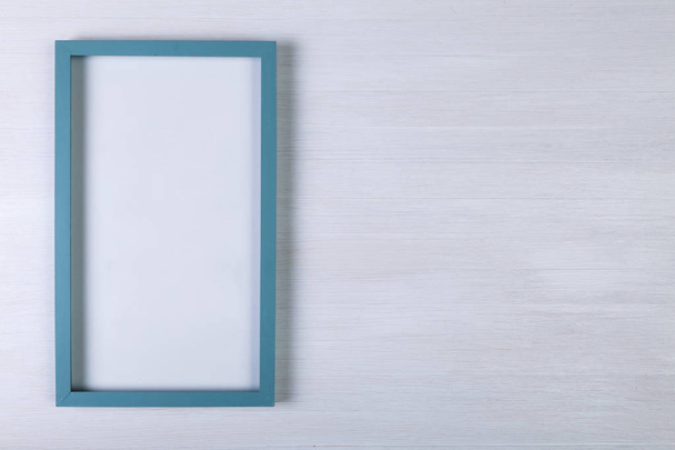 Blank photo frame on white wood background. - Fotó, kép
