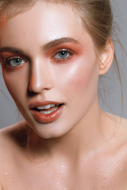 Beautiful portrait of a girl with wet make-up and shiny skin - Photo, Image
