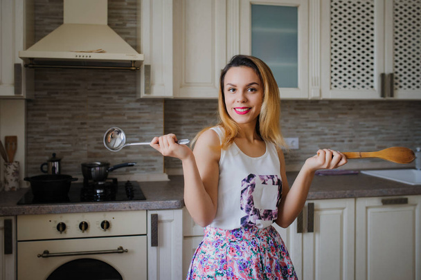 nuori nainen on ruoanlaitto keittiössä
 - Valokuva, kuva