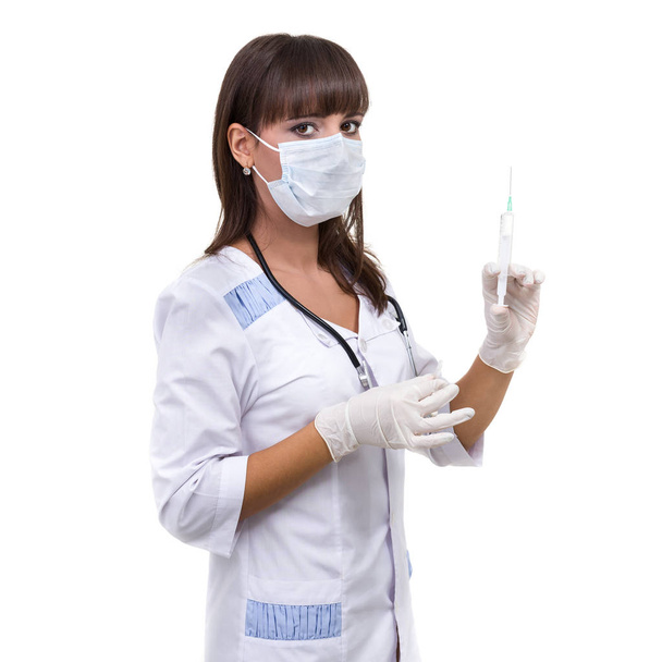 Young doctor woman with syringe against white background - Valokuva, kuva