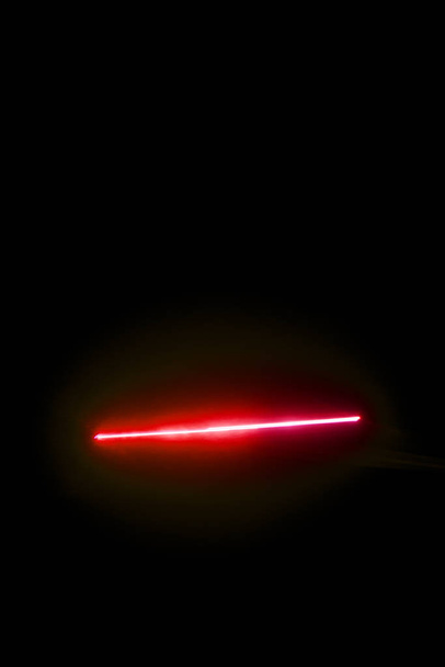 Laser beam red on a black background  - Photo, image