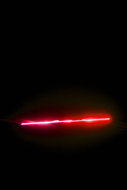 Laser beam red on a black background  - Fotografie, Obrázek