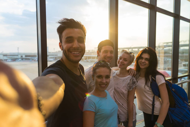 Young People Group In Airport Lounge Near Windows Happy Smile Mix Race Friends Taking Selfie Photo - Photo, Image