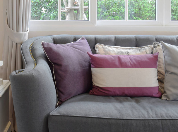 luxe woonkamer design met klassieke bank en decoratieve paarse kussens - Foto, afbeelding