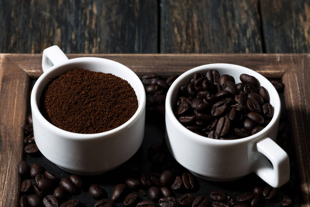 ground coffee and coffee beans in cups - Photo, image