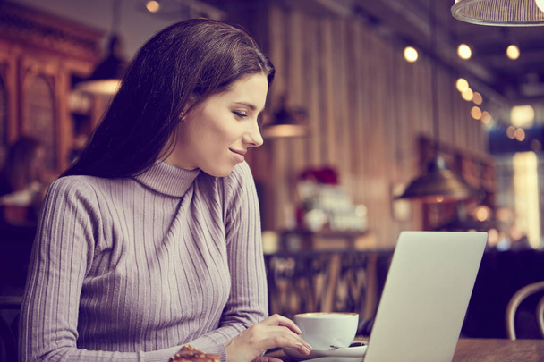woman working with laptop in cafe - Zdjęcie, obraz